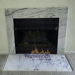 gas fireplace turned off with front marble hearth